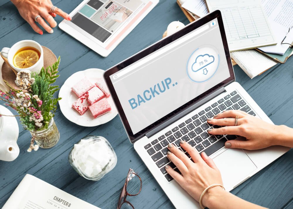 Person using a laptop displaying cloud backup